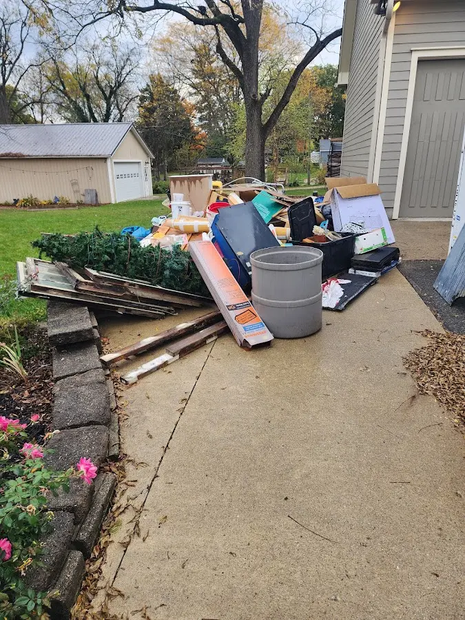 Dumpster being loaded with debris for 3 Yard Dumpster Rental in Minden